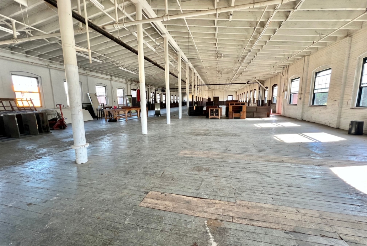 Warehouse in Yonkers, NY with high ceilings in an industrial zone as a commercial property.